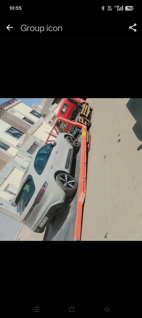 Tow truck with sports car on flatbed